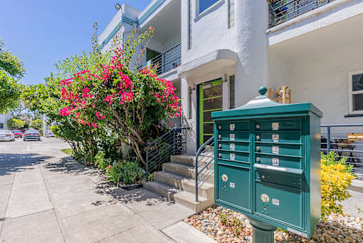 a mail box in front of a house with stairs