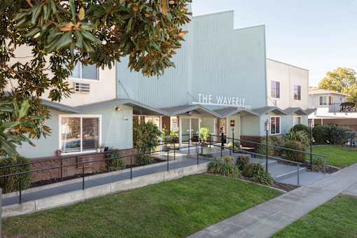 The Waverly building is a modern structure with a flat roof and large windows.