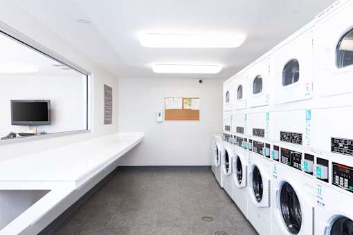 A row of washing machines in a laundromat.