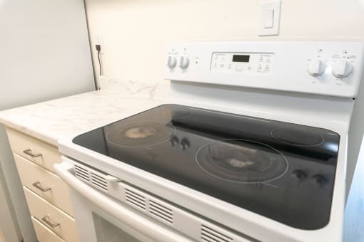 a white stove top oven sitting in a kitchen