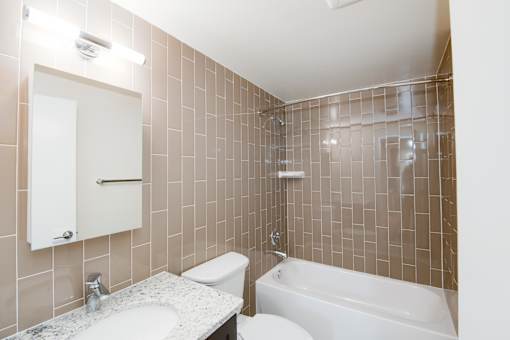 A bathroom with a white toilet, sink, and bathtub.