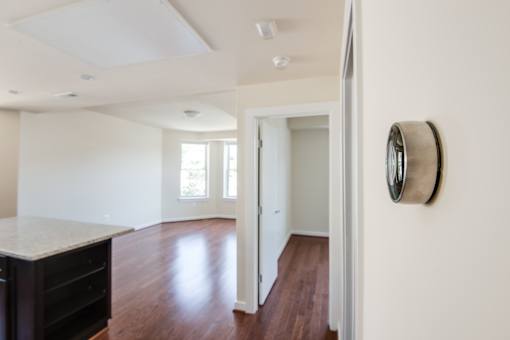 A room with a white ceiling and a brown floor.