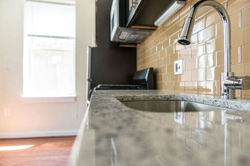 A kitchen with a sink and a window.