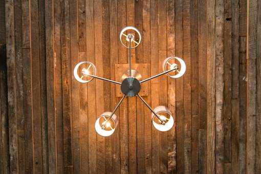 A chandelier with six lights hangs from a ceiling.