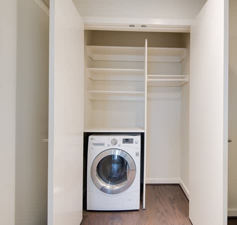A white washing machine in a small laundry room.