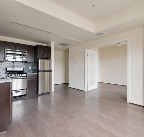 A kitchen with a stove top oven and a refrigerator.