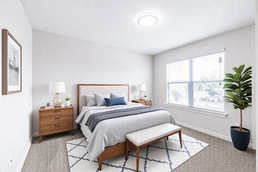 A bedroom with a bed, nightstand, and window.