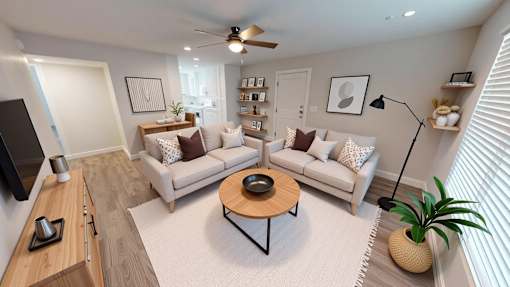A living room with a white couch and a coffee table.