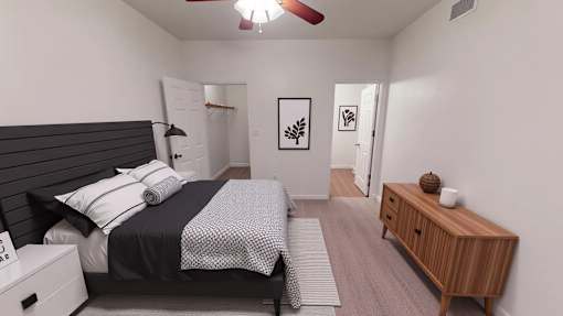 A bedroom with a bed, nightstand, and a wooden cabinet.