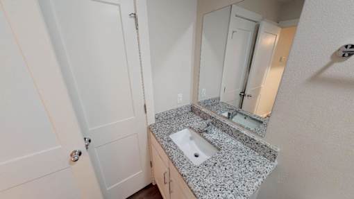 Bathroom vanity with Granite counter tops and LED lit mirror