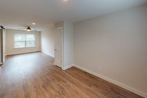 A room with wooden floors and a window.
