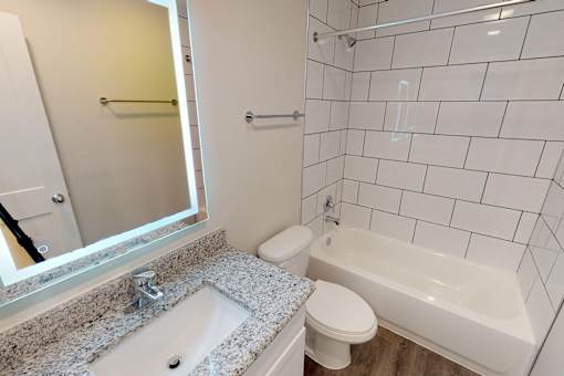 A white toilet sits next to a sink in a bathroom.