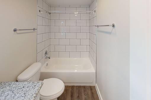 A white toilet and sink in a small bathroom.