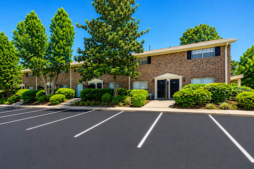 Apartment building exterior with parking lot at Stonetree Apartments, East Point, GA