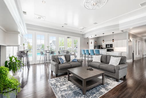 A living room with a grey sofa, a grey coffee table, and a white ceiling.