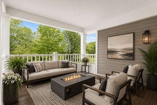 A cozy outdoor seating area with a fire pit in the center.