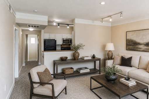 A living room with a chair, a table, and a couch.