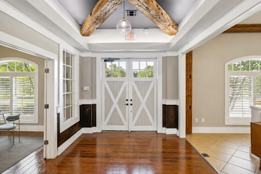 A room with a wooden floor and a white door.