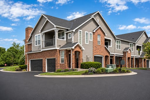 A large, two-story house with a brick facade and a garage.