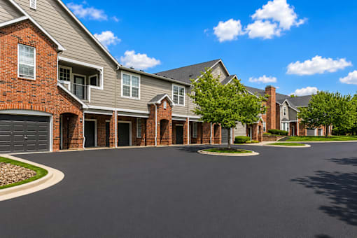 A residential area with houses and a paved road.