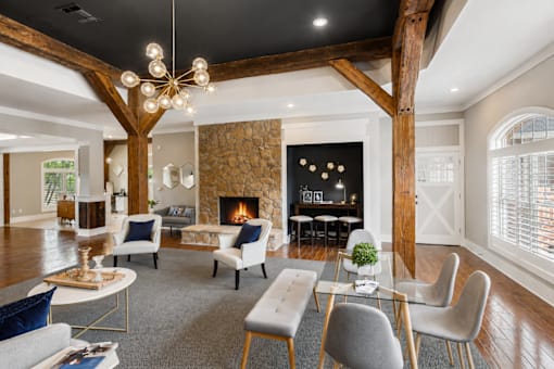 A modern living room with a fireplace and a dining table.