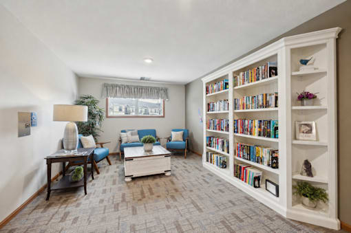 A living room with a bookshelf filled with books.