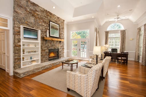 A living room with a stone fireplace and a couch.