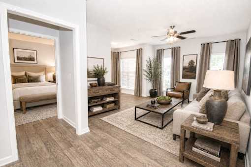 A living room with a white ceiling fan and a white couch.