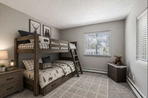 A bedroom with a bunk bed and a ladder.