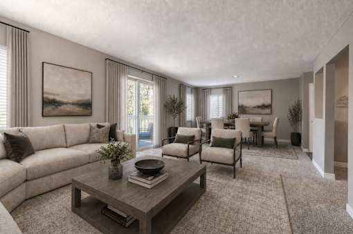 A living room with a sofa, chairs, and a coffee table.
