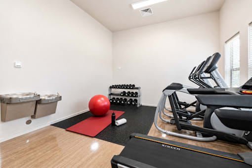 Fitness center with cardio equipment and free weights at Silver Ridge Apartments, Meridian, ID 83642