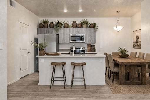 Open kitchen with breakfast bar and dining space at Silver Ridge Apartments, Idaho