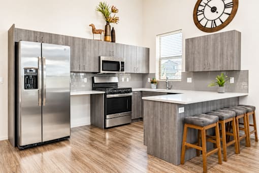 Contemporary kitchen with stainless steel appliances and peninsula at Silver Ridge Apartments, Idaho