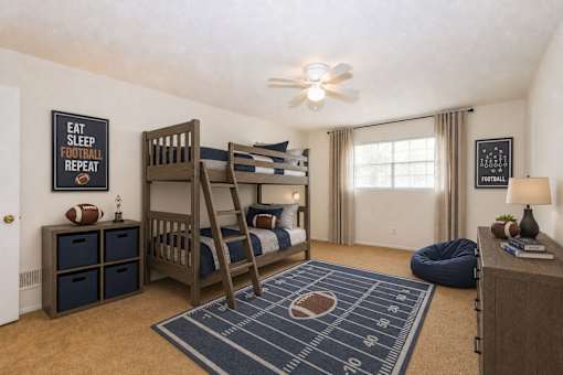 Bedroom with wooden bunk bed and football theme at Stonetree Apartments, East Point, 30344