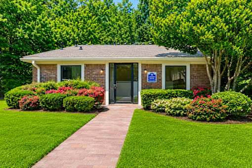 Leasing office with brick exterior and manicured lawn at Stonetree Apartments, Georgia