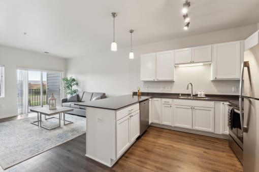 an open kitchen and living room with a couch and a table