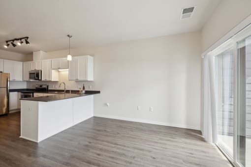 a kitchen and living room with a large window and