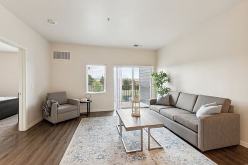 a living room with a couch and a chair and a coffee table