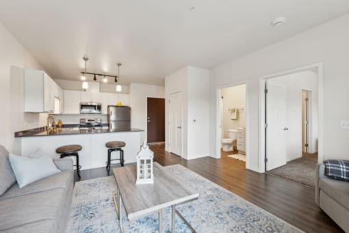 a living room and kitchen with a couch and a table