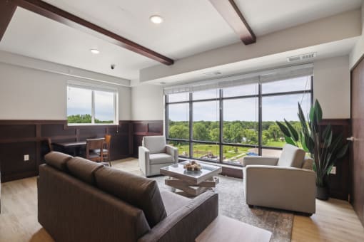 a living room with couches and chairs and a large window