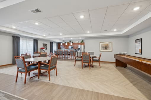 our resident dining room with tables and chairs and a piano