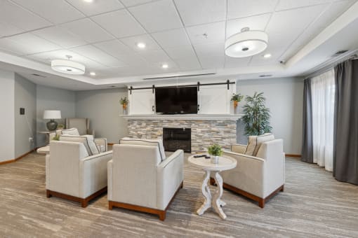the living room of our apartments atrium with couches and a fireplace
