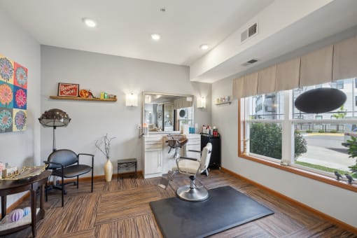 a living room with a table and chairs and a kitchen with a large window