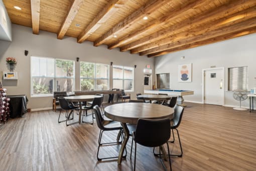 a dining room with tables and chairs and a pool table