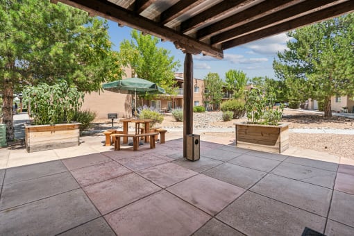 a patio with a table and an umbrella