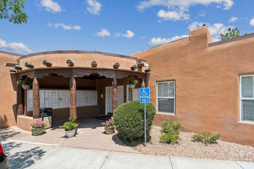 an orange building with a parking lot and a blue sign