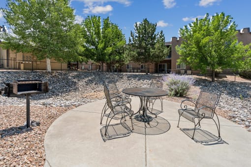 A patio with a table and chairs.