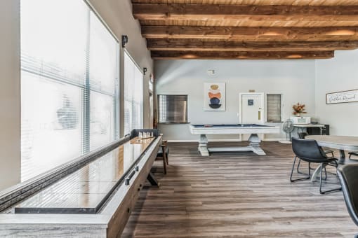 a room with a ping pong table and a pool table