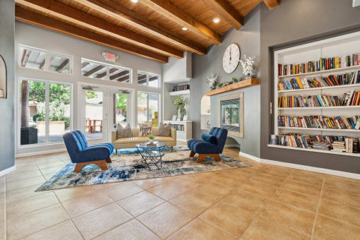 a living room with a fireplace and a bookshelf full of books