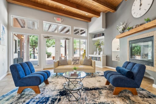 a living room with a couch and chairs and a fireplace